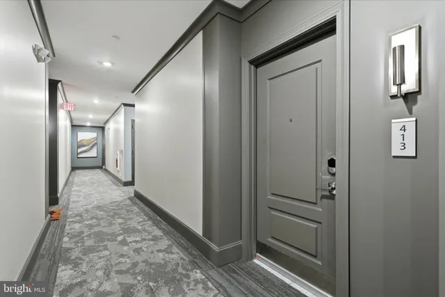 a kitchen with stainless steel appliances kitchen island granite countertop a sink a stove and a refrigerator