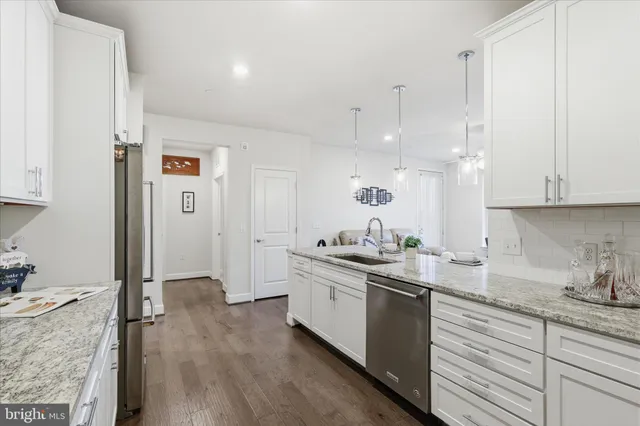 a living room with furniture wooden floor and a table