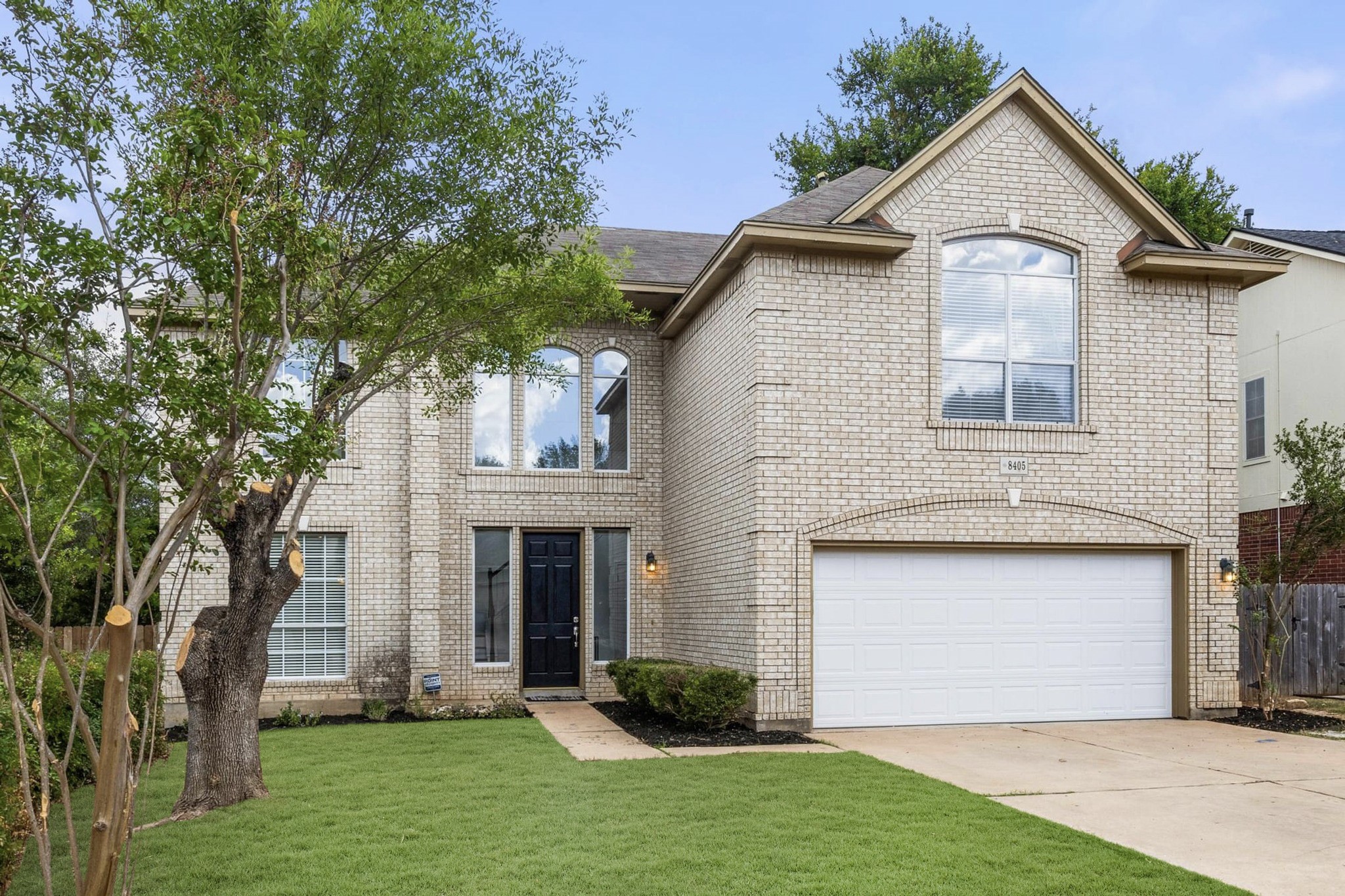 a front view of a house with a yard and garage