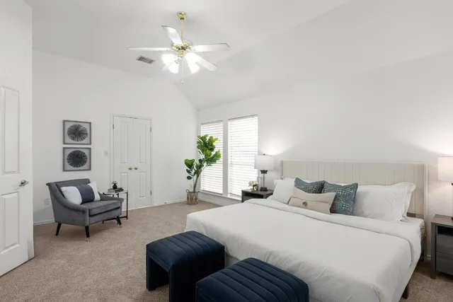 a bedroom with bed and a chandelier