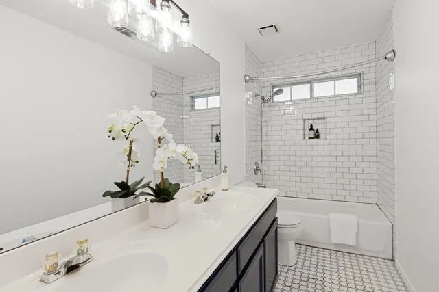 a bathroom with a sink a tub and shower
