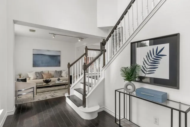 a living room with furniture and stairs