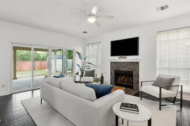 a living room with furniture a fireplace and a flat screen tv