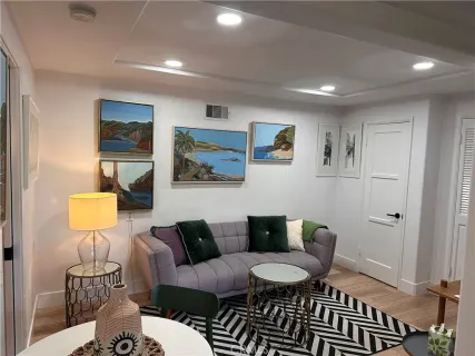 a living room with furniture and a lamp