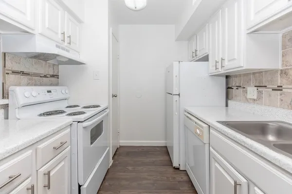 a kitchen with a sink a stove and cabinets