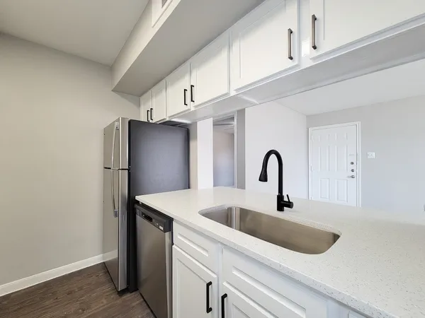 a view of kitchen with a sink and refrigerator