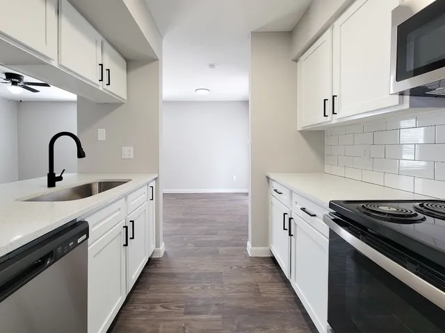 a kitchen with granite countertop a stove and a sink