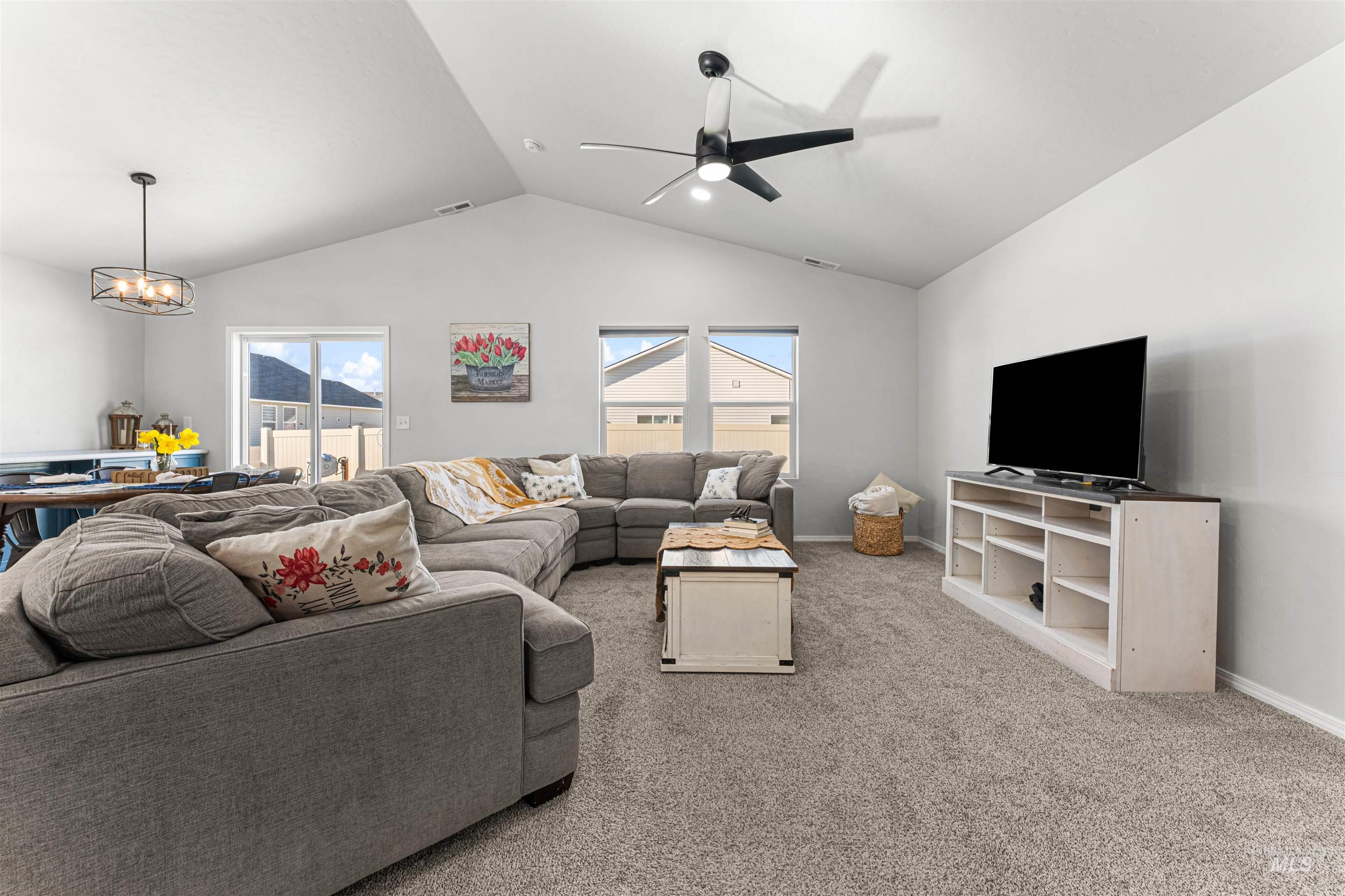 12342 Noreen Street Caldwell, ID 83607 - Photo 12 of 42 Living area featuring light colored carpet, ceiling fan, and suspended lighting