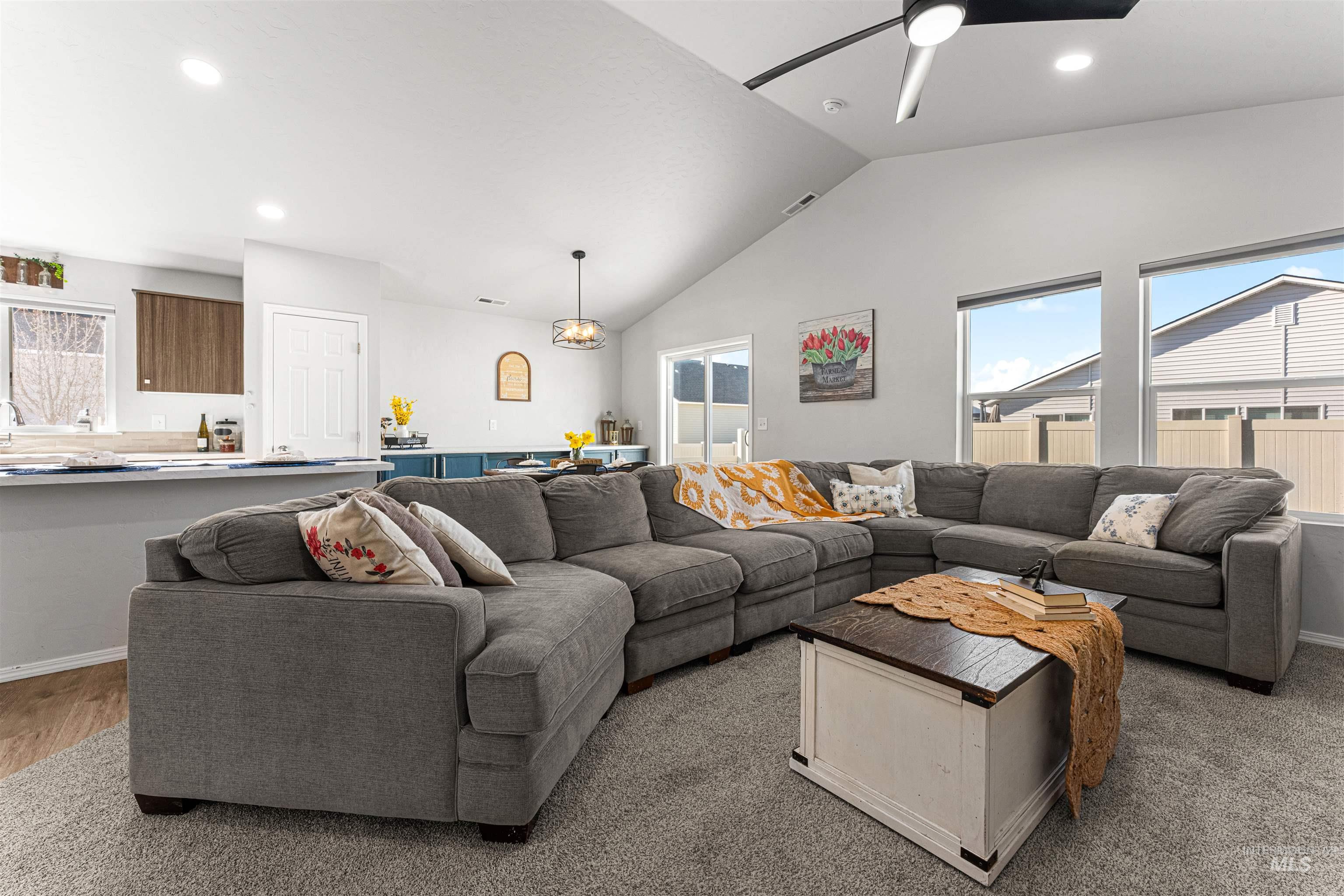 12342 Noreen Street Caldwell, ID 83607 - Photo 13 of 42 Living room featuring plenty of natural light, lofted ceiling, a ceiling fan, and recessed lighting
