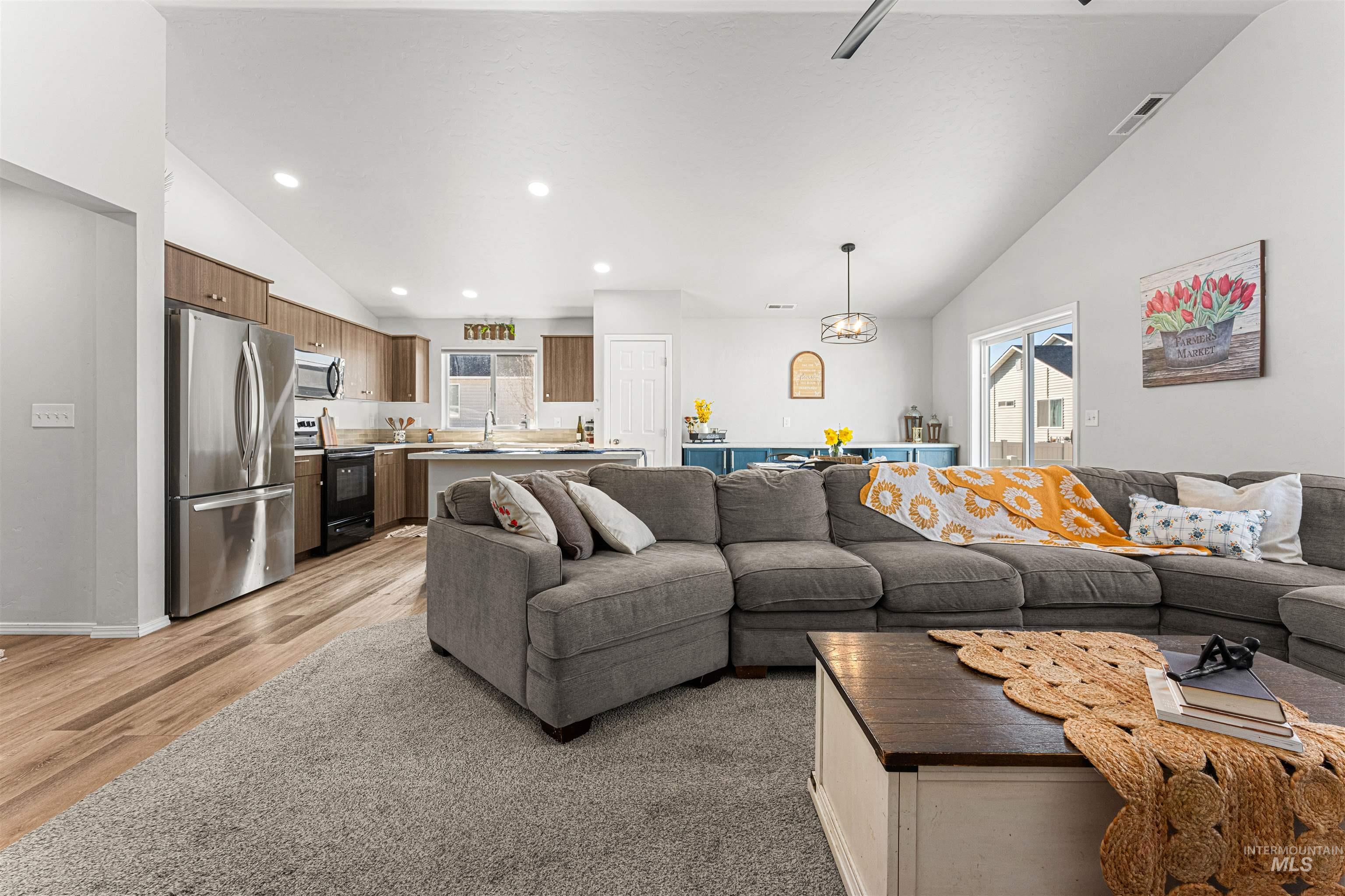 12342 Noreen Street Caldwell, ID 83607 - Photo 14 of 42 Living room featuring vaulted ceiling, light wood-style flooring, and recessed lighting