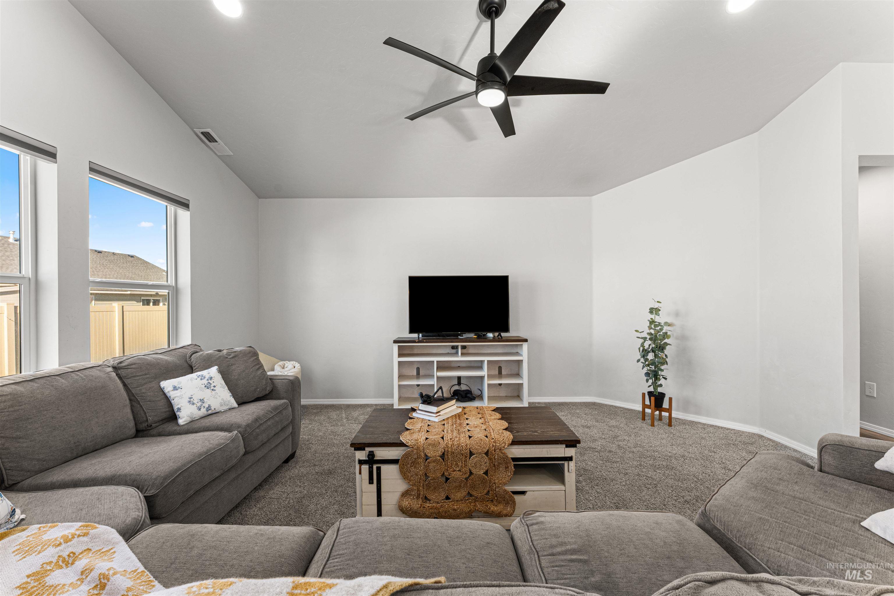 12342 Noreen Street Caldwell, ID 83607 - Photo 16 of 42 Living area featuring ceiling fan, carpet, vaulted ceiling, and recessed lighting