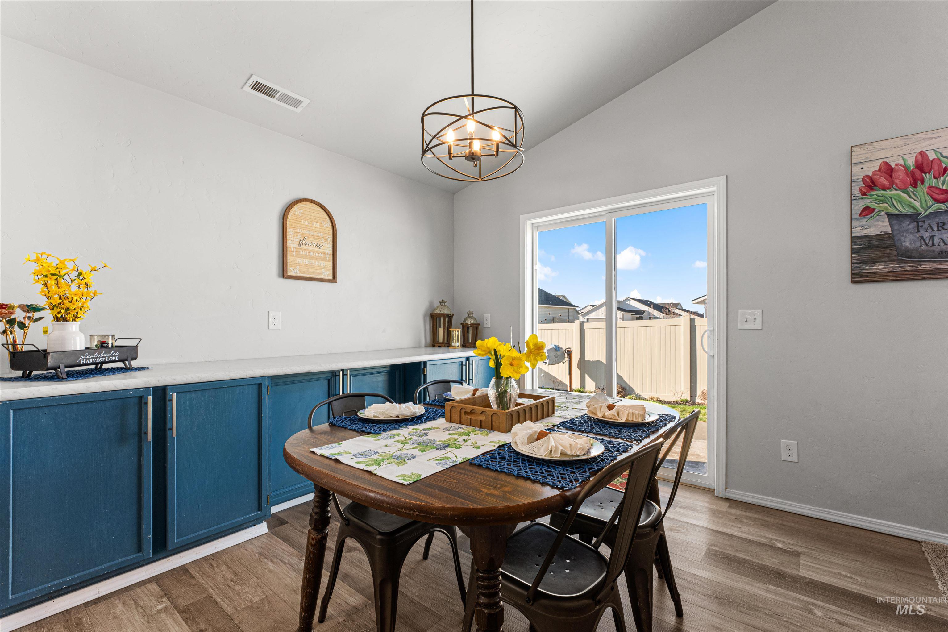 12342 Noreen Street Caldwell, ID 83607 - Photo 21 of 42 Dining room with vaulted ceiling, suspended lighting, dark wood finished floors, and beverage cooler