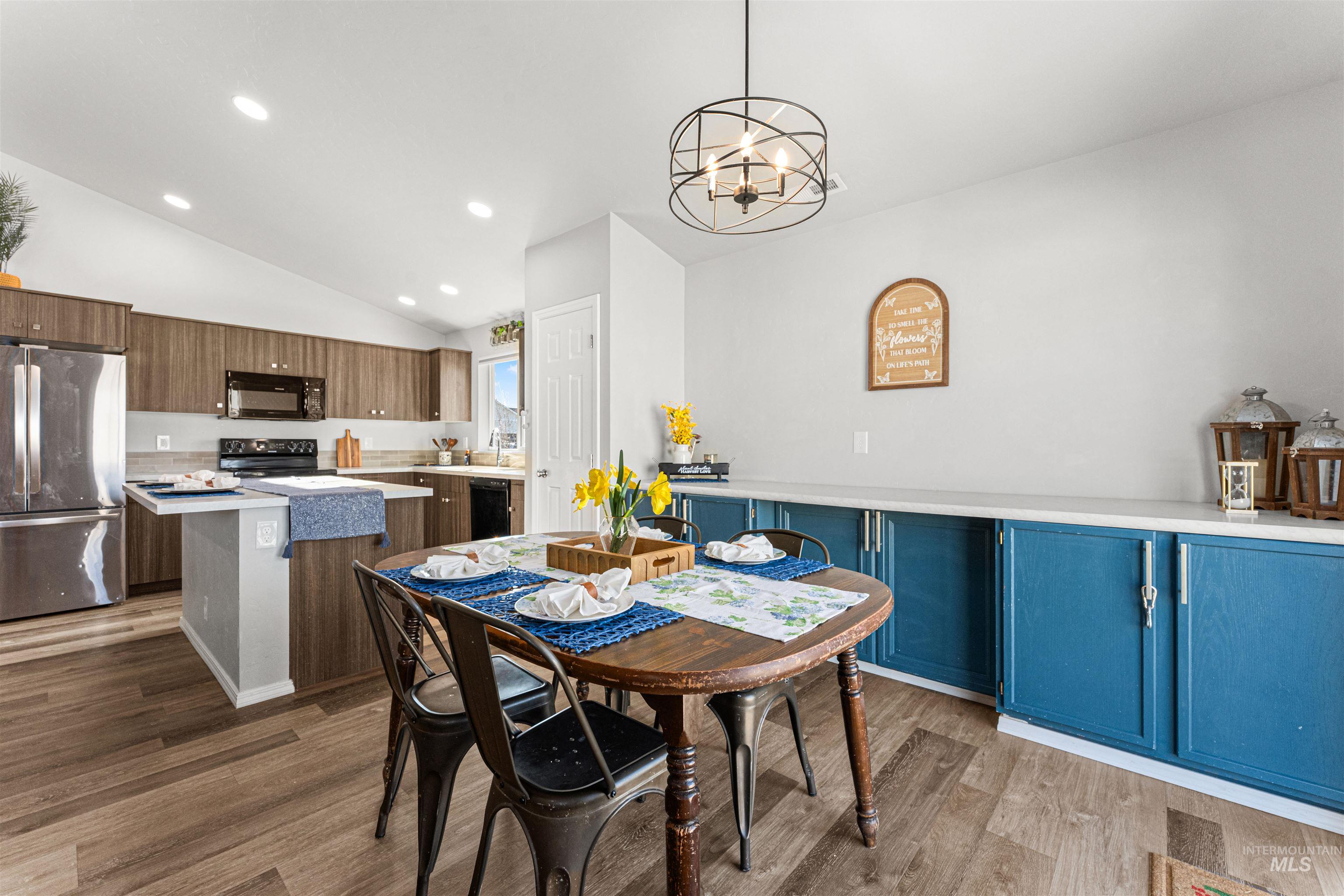 12342 Noreen Street Caldwell, ID 83607 - Photo 22 of 42 Dining space with vaulted ceiling, a chandelier, and dark wood finished floors