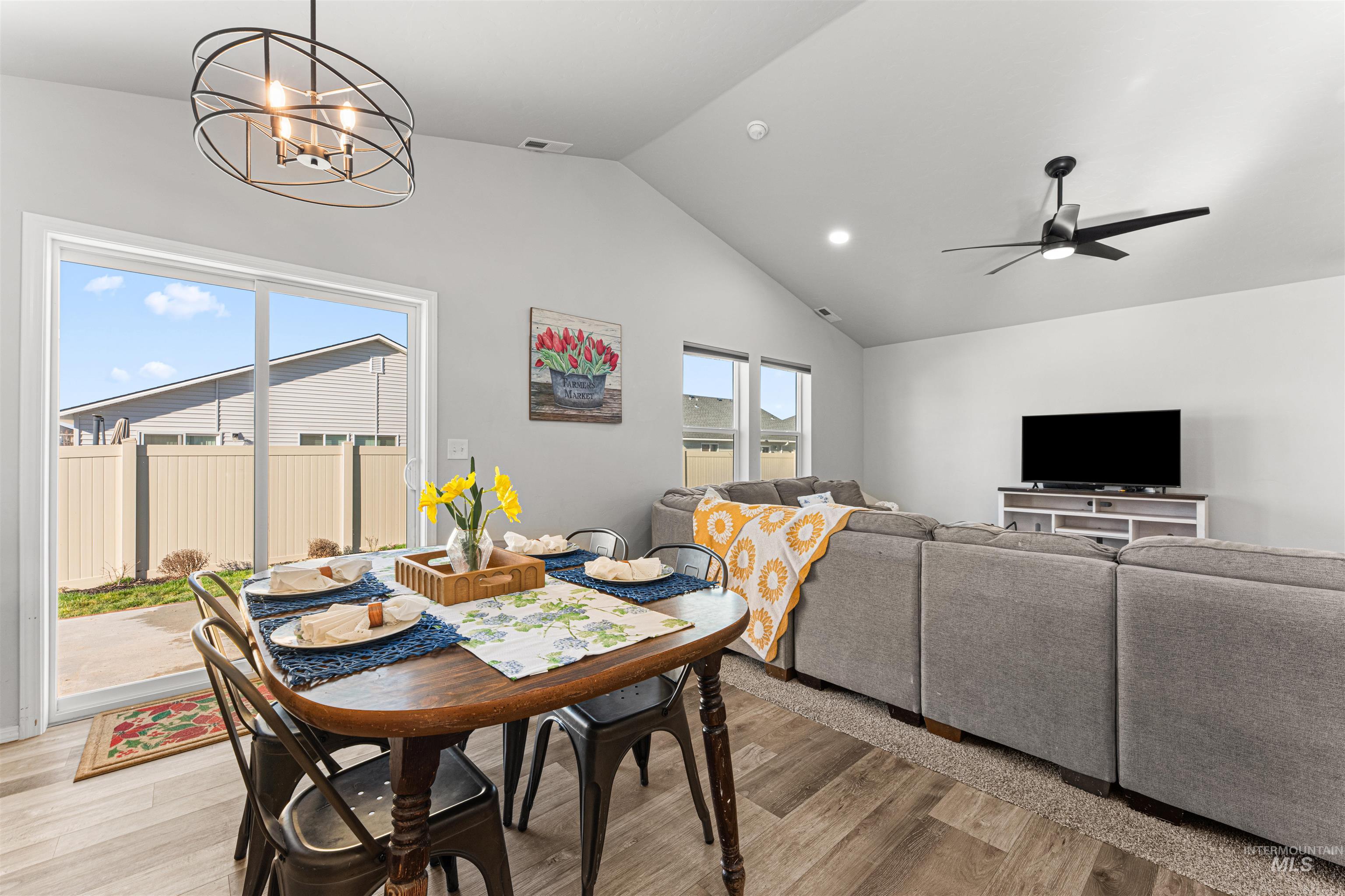12342 Noreen Street Caldwell, ID 83607 - Photo 23 of 42 Dining space featuring light wood-style flooring, a ceiling fan, hanging lights, and a high ceiling