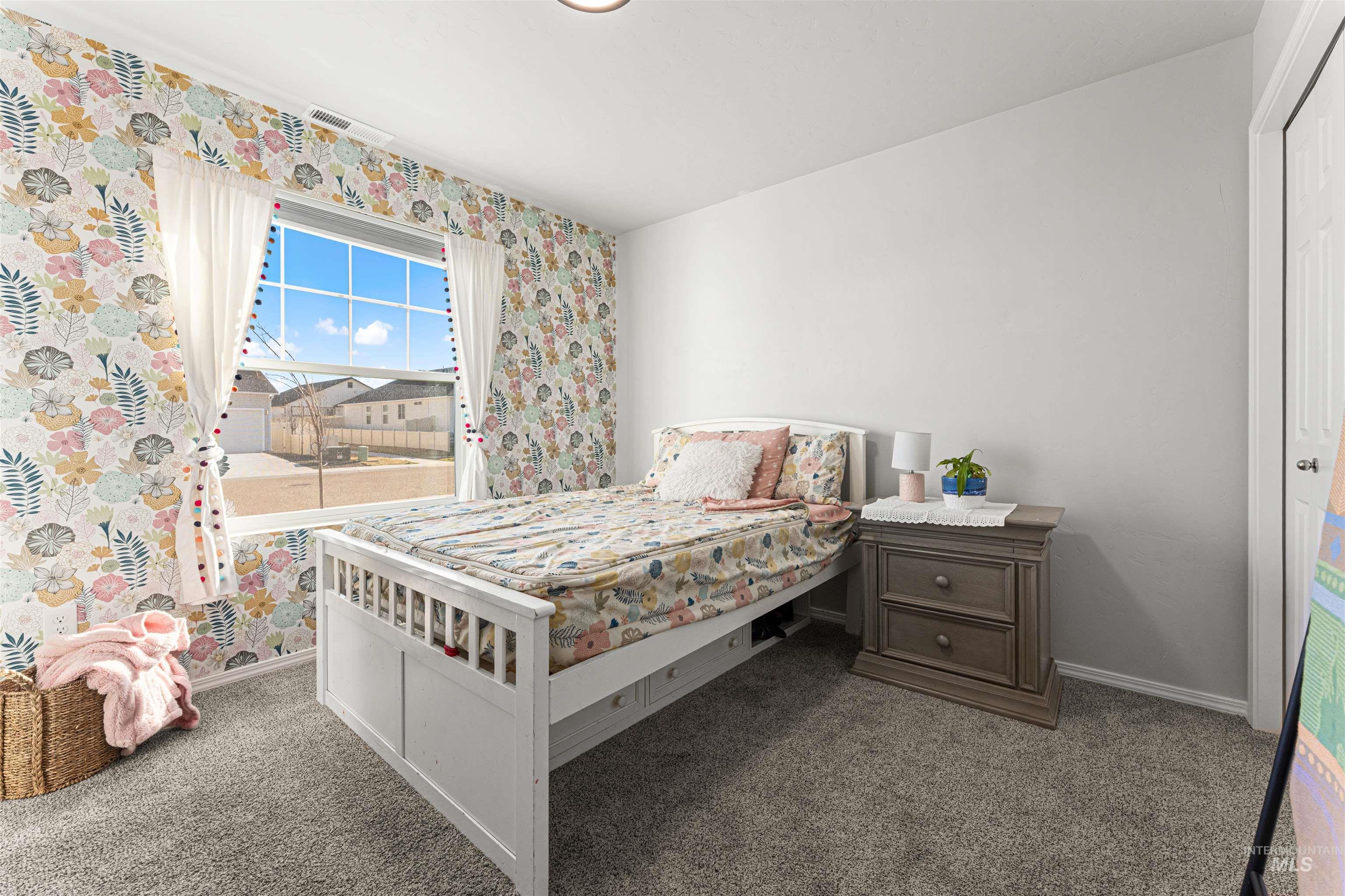 12342 Noreen Street Caldwell, ID 83607 - Photo 32 of 42 Bedroom featuring dark colored carpet and wallpapered walls