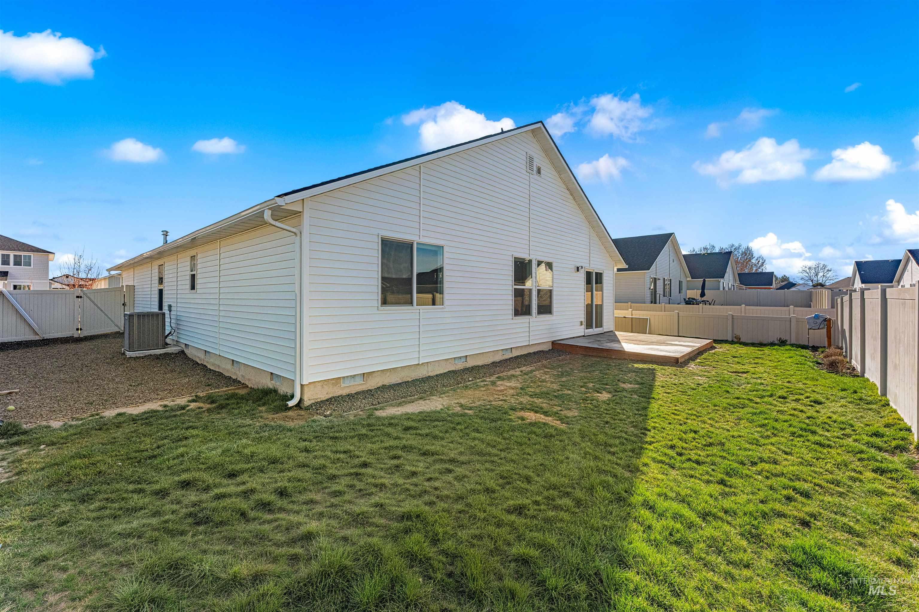 12342 Noreen Street Caldwell, ID 83607 - Photo 9 of 42 Back of property with crawl space, a gate, a fenced backyard, and a wooden deck