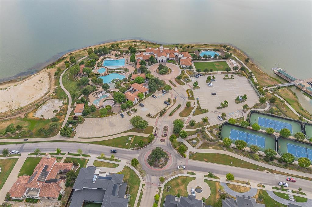 1205 Ivy Charm Way Arlington, TX 76005 - Photo 37 of 40 Waterfront property featuring multiple swimming pools, tennis courts, a private dock, and manicured landscaping