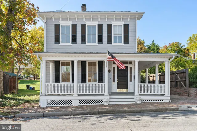 front view of a brick house with a yard