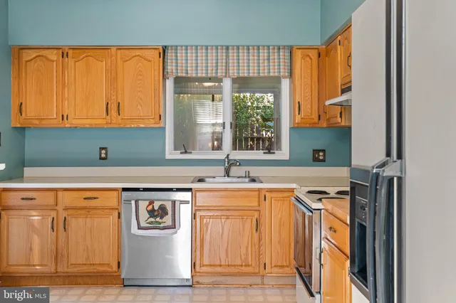 a kitchen with a sink and a refrigerator