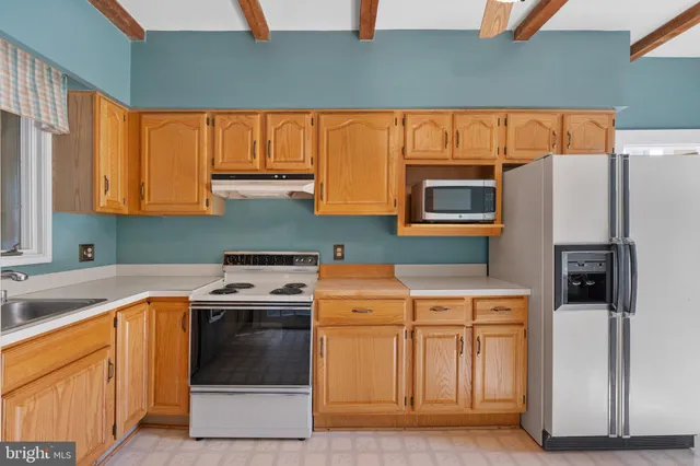 a view of a livingroom with a fireplace and window