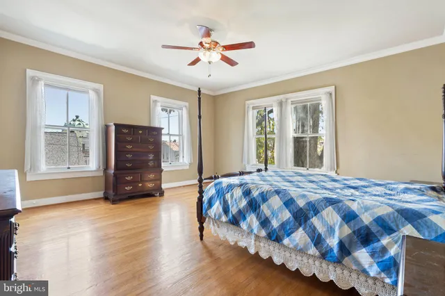 a spacious bedroom with a bed and a chandelier