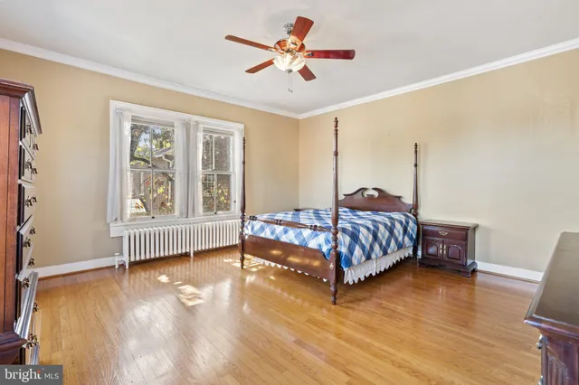 a living room with furniture and ceiling fan