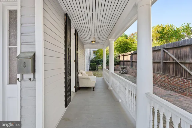 a view of backyard with a chair and table in the patio