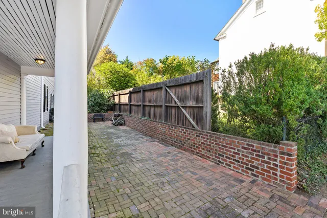 a backyard of a house with a table and chairs