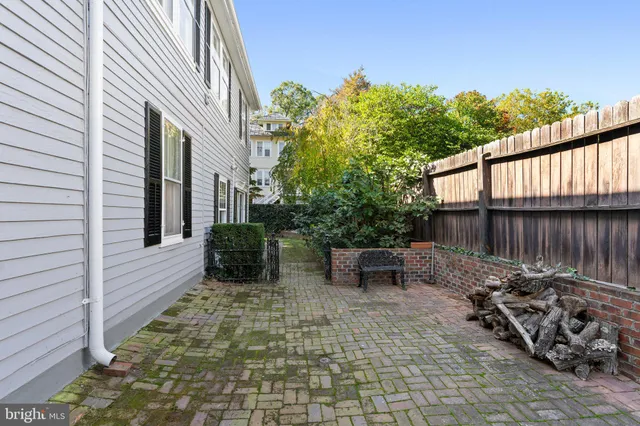 a backyard of a house with lots of green space and lake view
