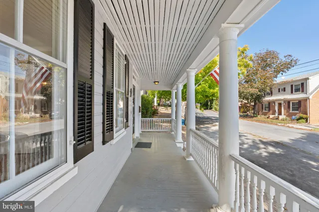 a view of a livingroom with wooden floor and stairs
