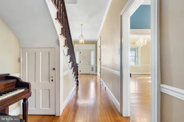 wooden floor fireplace and windows in an empty room