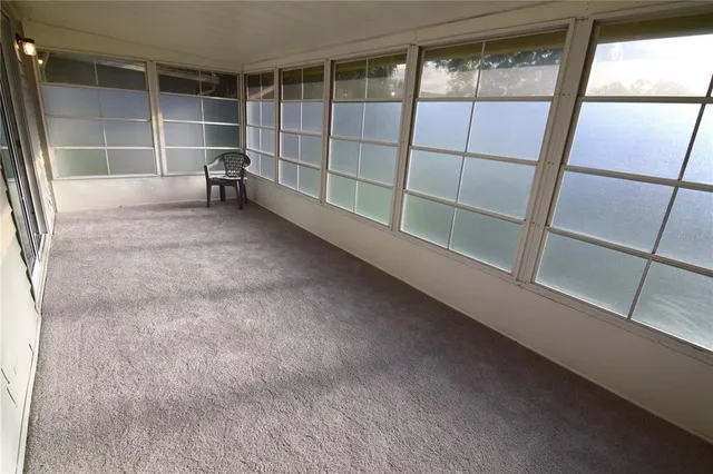 a view of a room with a window and wooden floor