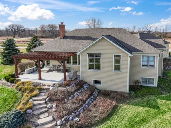 a view of a house with backyard and sitting area