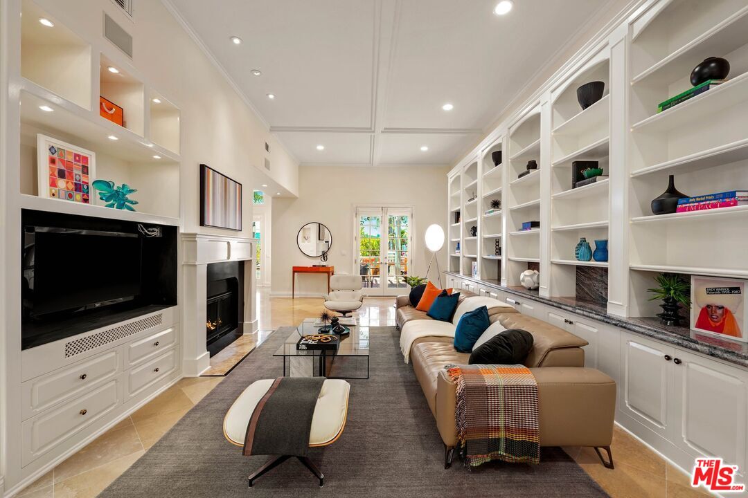 2305 Canyonback Road Los Angeles, CA 90049 - Photo 11 of 50 a living room with fireplace furniture and a flat screen tv