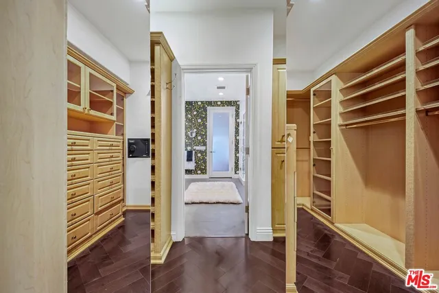 a view of a hallway with wooden floor and windows