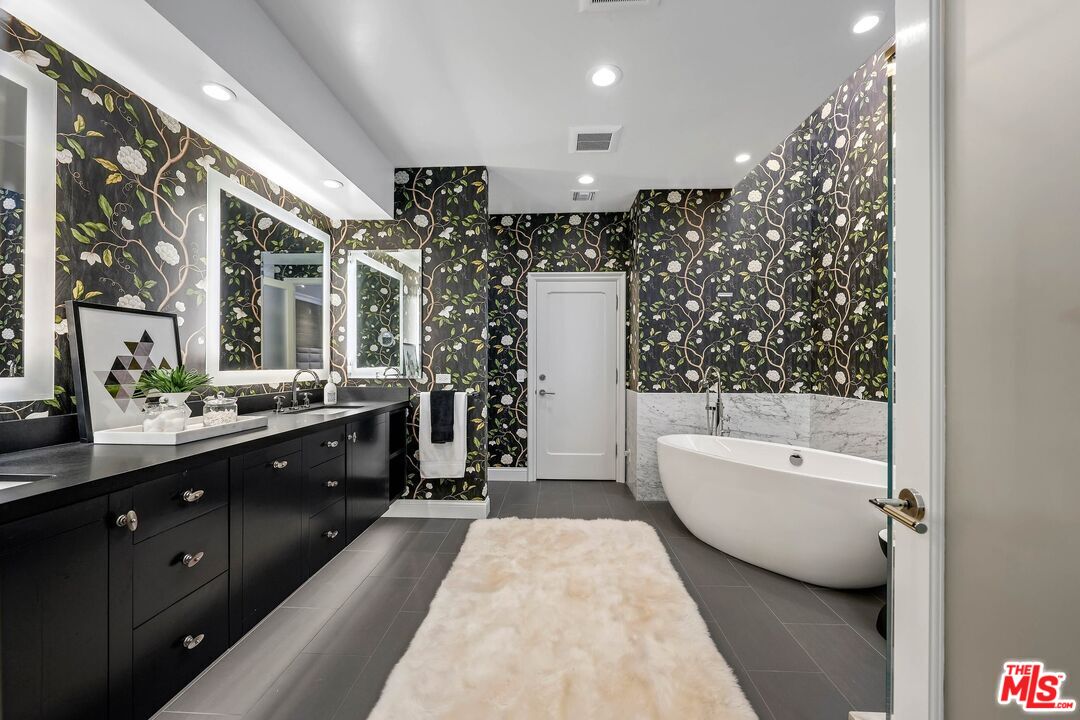 2305 Canyonback Road Los Angeles, CA 90049 - Photo 24 of 50 a spacious bathroom with a double vanity sink tub and mirror