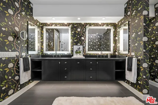 a bathroom with a double vanity sink and a mirror