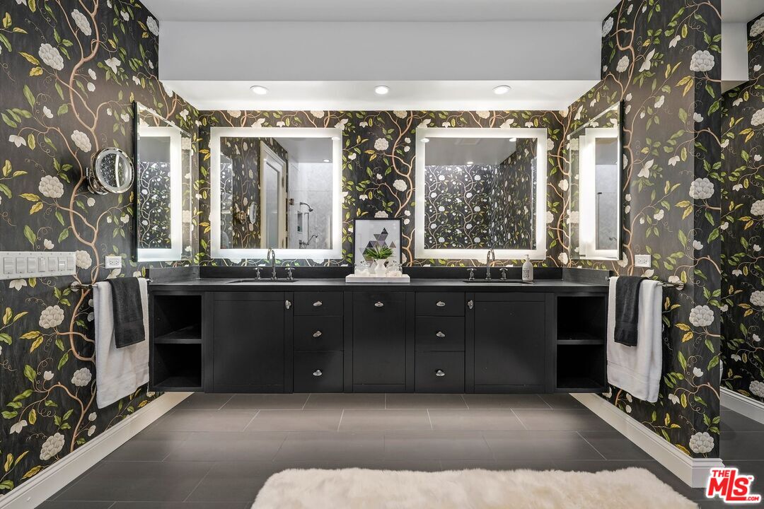 2305 Canyonback Road Los Angeles, CA 90049 - Photo 25 of 50 a bathroom with a double vanity sink and a mirror