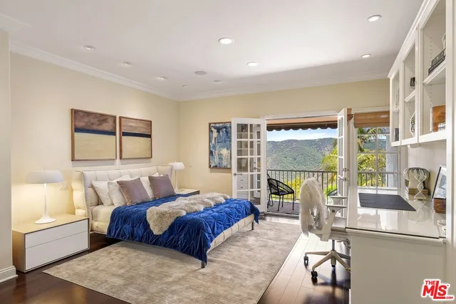 a bedroom with a large bed and a large window