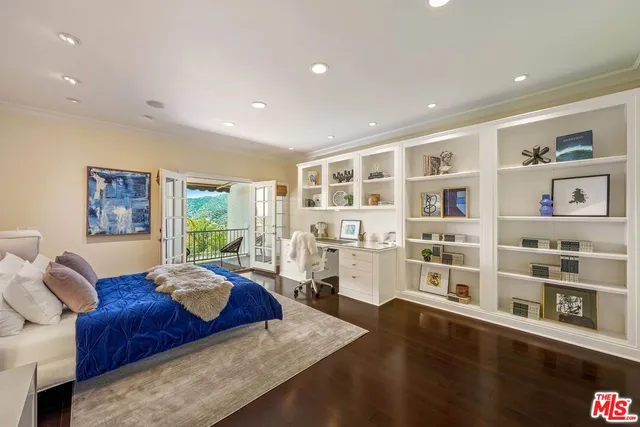 a living room with furniture and a book shelf