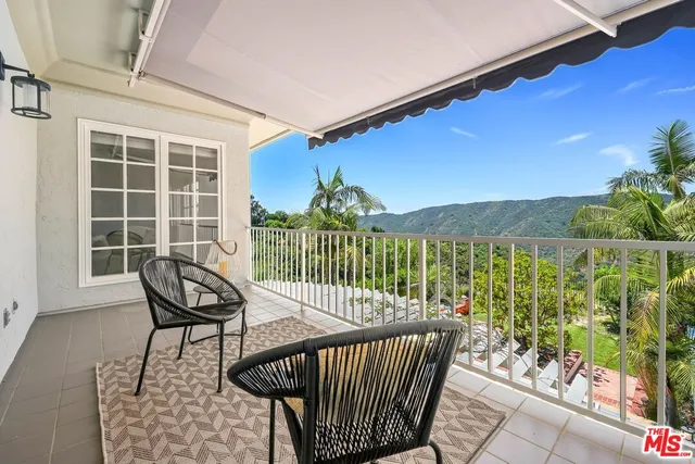 a view of a balcony with furniture