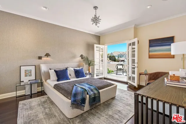 a living room with a bed furniture and next to a window