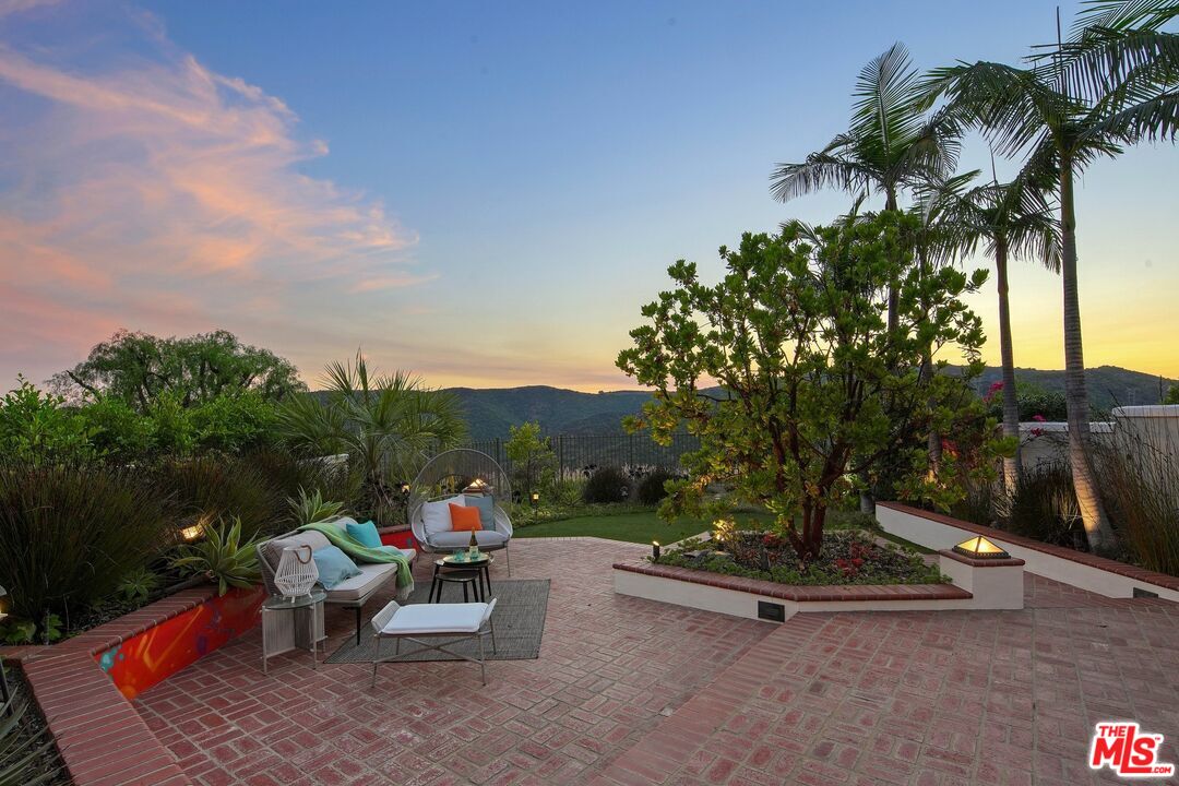 2305 Canyonback Road Los Angeles, CA 90049 - Photo 37 of 50 a view of a patio with a table and chairs