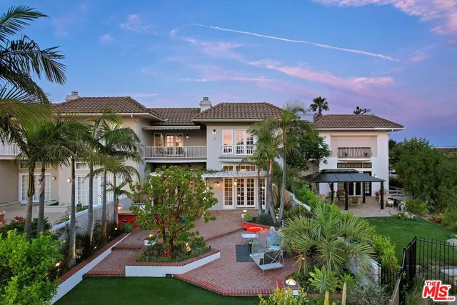 a front view of a house with yard and green space