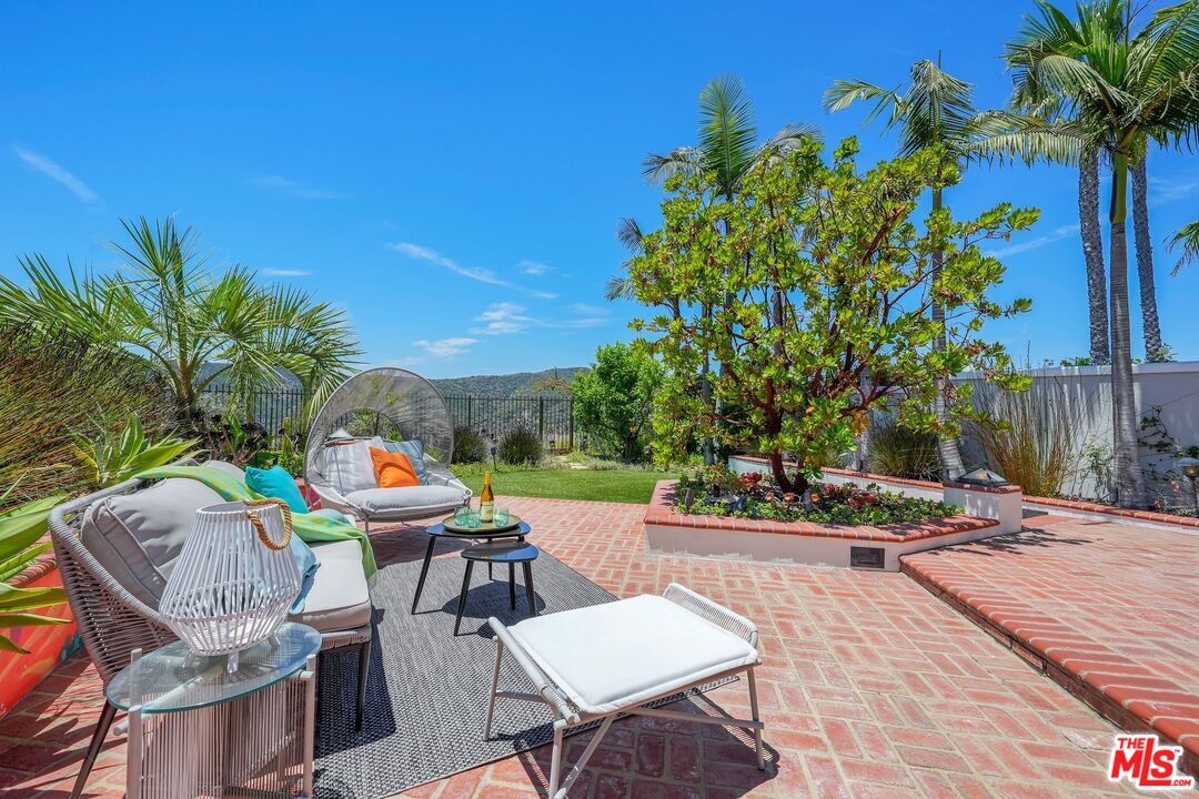 2305 Canyonback Road Los Angeles, CA 90049 - Photo 41 of 50 a view of a patio with table and chairs and potted plants