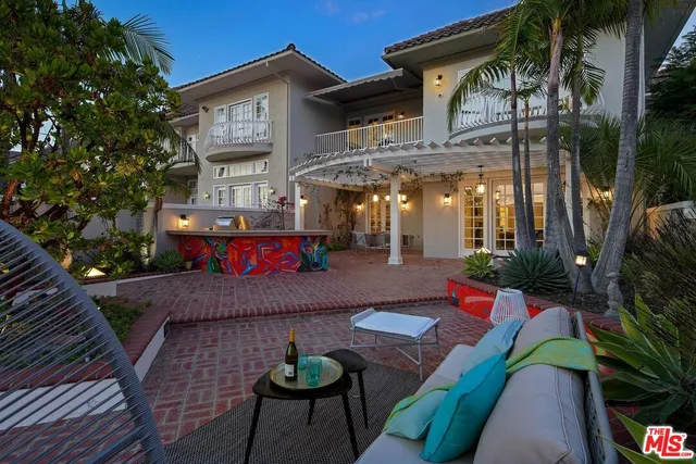 a view of a patio with table and chairs potted plants with wooden floor