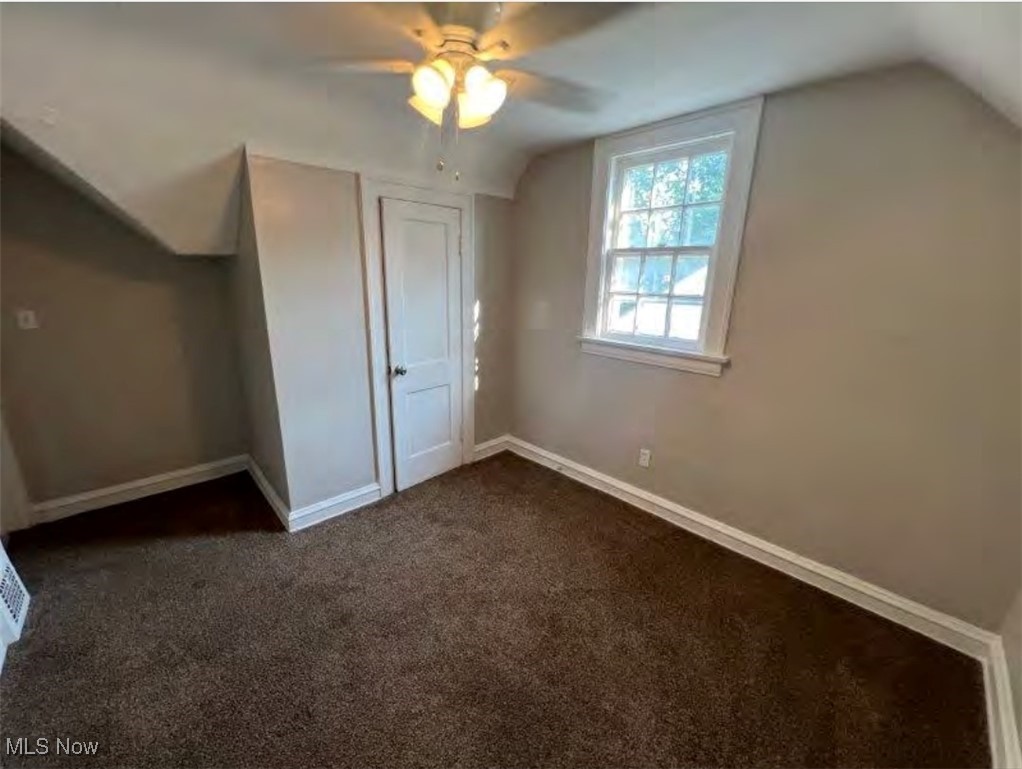 3579 Riedham Road Cleveland, OH 44120 - Photo 6 of 13 Unfurnished bedroom with lofted ceiling, ceiling fan, and dark colored carpet