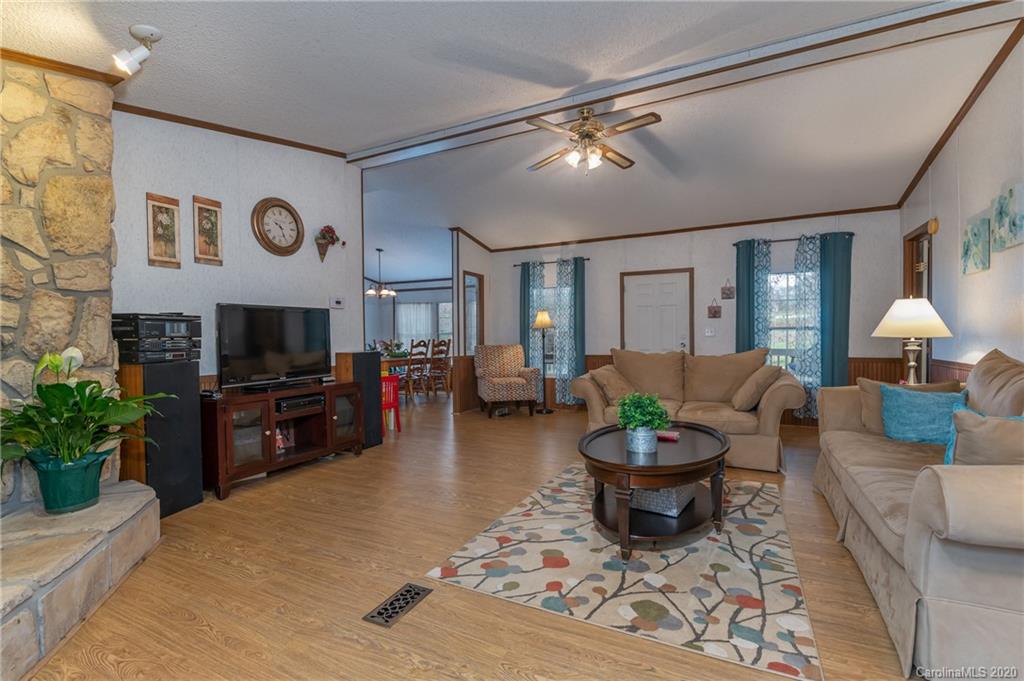 526 Parris Road Rutherfordton, NC 28139 - Photo 14 of 27 a living room with furniture a flat screen tv and a fireplace