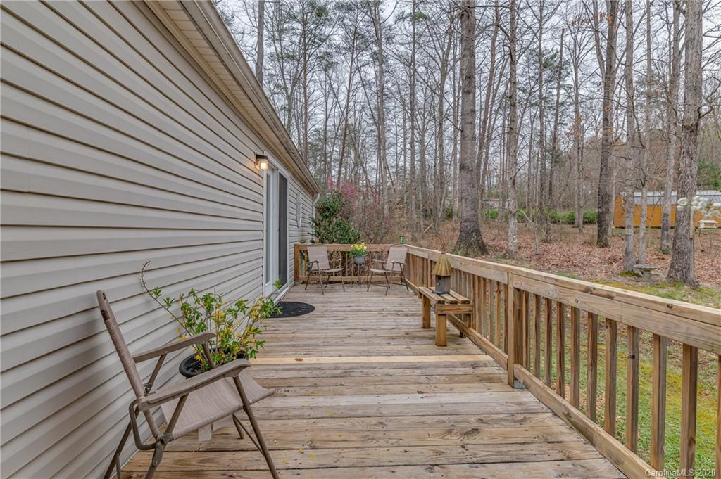 526 Parris Road Rutherfordton, NC 28139 - Photo 15 of 27 a view of balcony with wooden floor and outdoor seating