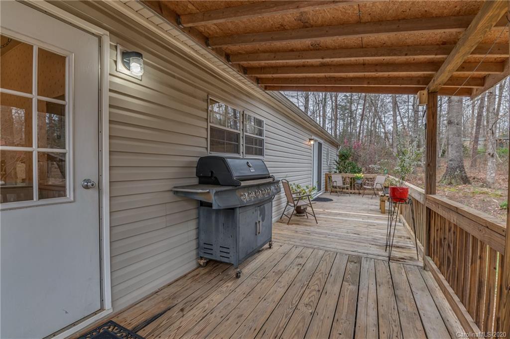 526 Parris Road Rutherfordton, NC 28139 - Photo 16 of 27 a view of a patio with table and chairs with wooden floor and fence